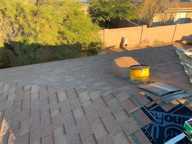 Shingle roof repair Tucson hero image Universal Roofing crew performing shingle roof repair in Tucson